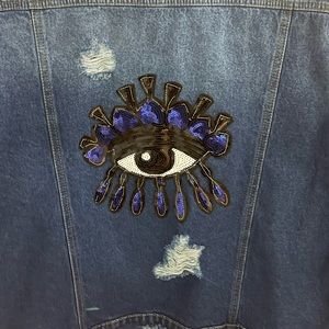 New oversized unisex jean jacket size med. Distressed with evil eye on back